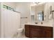 Well-lit bathroom with a single sink vanity and patterned tile flooring at 24348 S 201St Ct, Queen Creek, AZ 85142