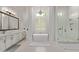 Bright bathroom with soaking tub, frameless shower and designer fixtures at 24348 S 201St Ct, Queen Creek, AZ 85142