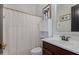 Cozy bathroom featuring a decorative shower curtain, storage, and a sink with a vanity at 24348 S 201St Ct, Queen Creek, AZ 85142
