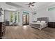 Spacious bedroom boasts tray ceilings, natural light and a cozy sitting area at 24348 S 201St Ct, Queen Creek, AZ 85142