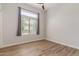 Comfortable bedroom featuring wood floors, a ceiling fan, and great natural light at 24348 S 201St Ct, Queen Creek, AZ 85142