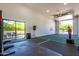 Spacious bonus room featuring an open concept, garage door, and access to the patio area at 24348 S 201St Ct, Queen Creek, AZ 85142
