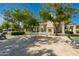 Beautiful community space featuring a fireplace, tables, and decorative sculptures on a sunny day at 24348 S 201St Ct, Queen Creek, AZ 85142