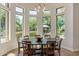 Bright dining area with a round table and large windows overlooking the landscaped backyard at 24348 S 201St Ct, Queen Creek, AZ 85142