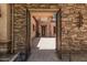Inviting entryway showcases stonework and lush landscaping, offering a glimpse of the home's elegance at 24348 S 201St Ct, Queen Creek, AZ 85142
