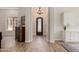 Inviting foyer with hardwood floors, a chandelier, and an ornate front door, creating a welcoming atmosphere at 24348 S 201St Ct, Queen Creek, AZ 85142
