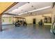 Garage space featuring a golf cart, epoxy flooring, ample storage space and an open garage door at 24348 S 201St Ct, Queen Creek, AZ 85142