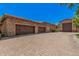 Spacious three-car garage with a paver driveway, providing ample parking and curb appeal at 24348 S 201St Ct, Queen Creek, AZ 85142
