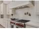 Gourmet kitchen featuring a stainless steel range, pot filler, and modern white cabinetry at 24348 S 201St Ct, Queen Creek, AZ 85142
