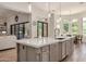 Kitchen island offering stone countertops, stainless sink and faucet, plus barstool seating at 24348 S 201St Ct, Queen Creek, AZ 85142