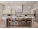 Spacious kitchen with white cabinetry, stainless steel appliances, and a large island with bar seating at 24348 S 201St Ct, Queen Creek, AZ 85142