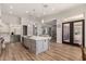 Open kitchen featuring a large gray island, stainless appliances, and access to the living area at 24348 S 201St Ct, Queen Creek, AZ 85142