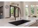 Contemporary kitchen with a dark undermount sink, stone countertop, and gooseneck faucet at 24348 S 201St Ct, Queen Creek, AZ 85142