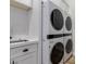 Well-equipped laundry room showcasing stacked washer/dryer, offering convenience and space-saving design at 24348 S 201St Ct, Queen Creek, AZ 85142