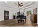 Elegant living room showcases wood floors, modern lighting and grand piano at 24348 S 201St Ct, Queen Creek, AZ 85142