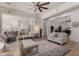Open living room featuring sofas, wood floors, and views into the kitchen and bonus room at 24348 S 201St Ct, Queen Creek, AZ 85142