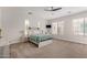 Serene main bedroom with large windows, neutral walls and carpet, and comfortable furnishings at 24348 S 201St Ct, Queen Creek, AZ 85142