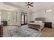 Spacious main bedroom with wood floors, a decorative rug, and large windows for natural light at 24348 S 201St Ct, Queen Creek, AZ 85142