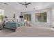 Spacious main bedroom featuring carpeting, a ceiling fan, and bright natural light at 24348 S 201St Ct, Queen Creek, AZ 85142