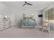 Spacious main bedroom featuring carpeting, a ceiling fan, and natural light at 24348 S 201St Ct, Queen Creek, AZ 85142