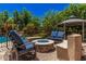 Outdoor patio featuring a cozy fire pit and comfortable seating area at 24348 S 201St Ct, Queen Creek, AZ 85142