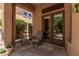 Covered patio with cushioned seating, offering a cozy outdoor living space for relaxation at 24348 S 201St Ct, Queen Creek, AZ 85142