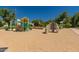 Community playground with slides, climbing structures, and a soft sandy surface for safe play at 24348 S 201St Ct, Queen Creek, AZ 85142