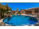 Inviting pool with a rock feature and lounge chairs, all set against a backdrop of manicured landscaping at 24348 S 201St Ct, Queen Creek, AZ 85142