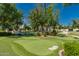 Community putting green with manicured landscaping and a sand trap at 24348 S 201St Ct, Queen Creek, AZ 85142