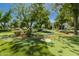Community putting green with manicured landscaping and mature trees at 24348 S 201St Ct, Queen Creek, AZ 85142