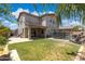 The backyard features a pool with waterfall feature, covered patio, grass, and some foliage at 2741 S Gordon --, Mesa, AZ 85209