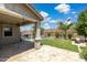 This backyard has a covered patio, a pool with a waterfall feature, grass, a fence, and palm trees at 2741 S Gordon --, Mesa, AZ 85209