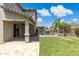 A backyard shows a pool with waterfall feature, grass, a covered patio, and a fence at 2741 S Gordon --, Mesa, AZ 85209