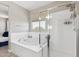 Well-lit bathroom includes a soaking tub and walk-in shower with glass doors, perfect for relaxation and rejuvenation at 2741 S Gordon --, Mesa, AZ 85209