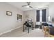 This bedroom features a ceiling fan, gray walls, a black desk and neutral carpet at 2741 S Gordon --, Mesa, AZ 85209