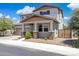 Charming two-story home boasts a well-maintained yard and inviting front porch with stone accents at 2741 S Gordon --, Mesa, AZ 85209