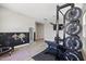 Well-equipped home gym featuring weight training equipment, rubber mats, and wood-look floors at 2741 S Gordon --, Mesa, AZ 85209