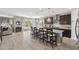 Open-concept kitchen with granite countertops, dark wood cabinets, and an island with bar seating at 2741 S Gordon --, Mesa, AZ 85209