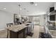Gourmet kitchen with granite countertops, dark cabinetry, and a spacious island, seamlessly flowing into the living area at 2741 S Gordon --, Mesa, AZ 85209