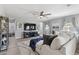 Bright living room with plush white sofa, ceiling fan, and entertainment center at 2741 S Gordon --, Mesa, AZ 85209