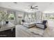 Bright living room featuring a large sectional sofa, ceiling fan and neutral tones at 2741 S Gordon --, Mesa, AZ 85209