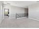 Upstairs loft area with carpet; features a wrought-iron railing and open layout at 2741 S Gordon --, Mesa, AZ 85209