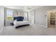 Bright main bedroom features a plush blue bed, ceiling fan, and ensuite bathroom for ultimate relaxation at 2741 S Gordon --, Mesa, AZ 85209