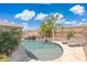 The backyard pool has a waterfall feature, lounge chairs, and a palm tree at 2741 S Gordon --, Mesa, AZ 85209