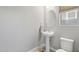 Neat powder room featuring a pedestal sink, oval mirror, and a modern toilet at 2741 S Gordon --, Mesa, AZ 85209