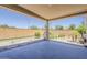 Covered patio featuring a garden, rock landscaping, and exterior boundary wall at 27413 W Tonopah Dr, Buckeye, AZ 85396