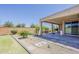 Backyard oasis with a covered patio, a garden and exterior block wall at 27413 W Tonopah Dr, Buckeye, AZ 85396