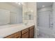 Bright bathroom featuring a vanity with a large mirror and a combined bathtub and shower at 27413 W Tonopah Dr, Buckeye, AZ 85396