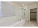 A modern bathroom features a luxurious tub and a glass-enclosed shower stall at 27413 W Tonopah Dr, Buckeye, AZ 85396