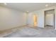 Spacious carpeted bedroom with multiple doorways to an en suite bathroom and closet at 27413 W Tonopah Dr, Buckeye, AZ 85396